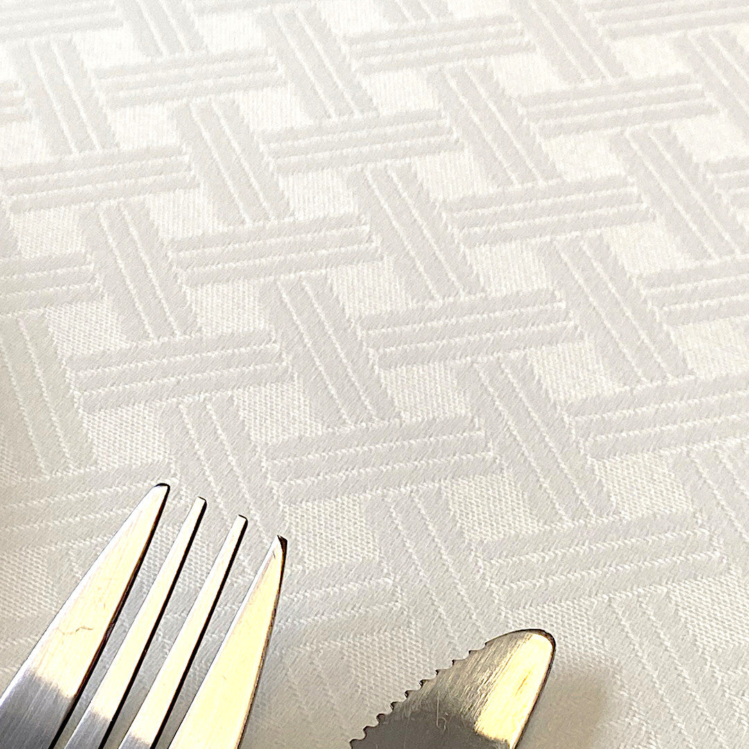 Benlliure Blanco – Jacquardvävd textilvaxduk med flätat mönster, närbild