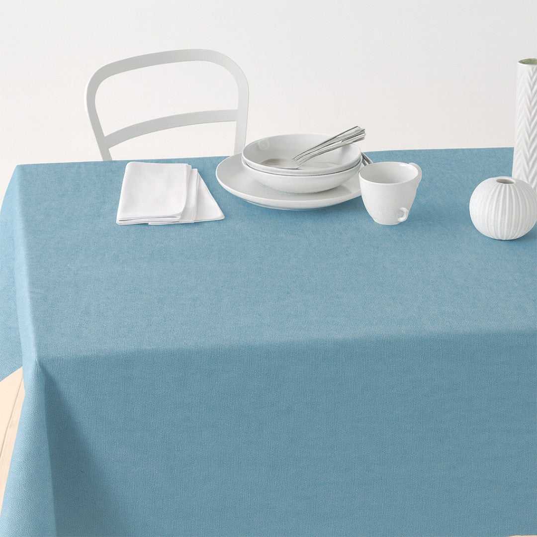 Nordfavn Dean Dämpad Blå – Enfärgad textilvaxduk i linnelook, på bord