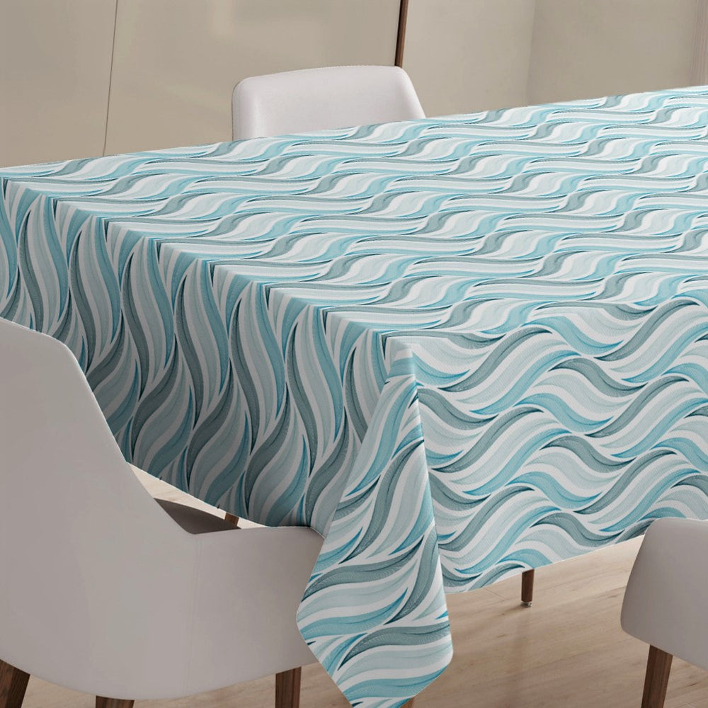 På bordet Böljan Blå - Vaxduk med grafiska vågor