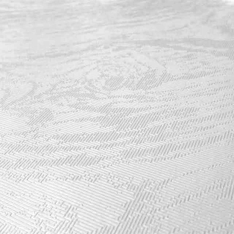 Närbild av Fiona, enfärgad vit vaxduk med ett fint diskret mönster