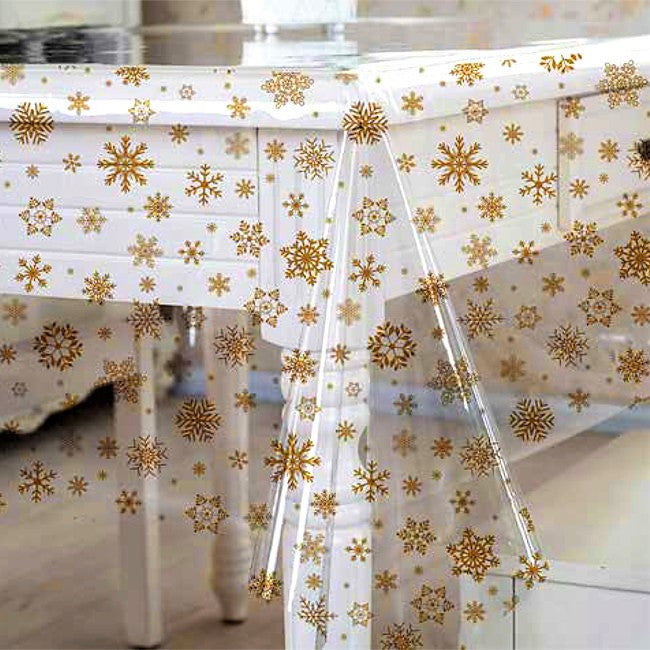 Gyllene snö på genomskinlig plast med snöflingar av guld