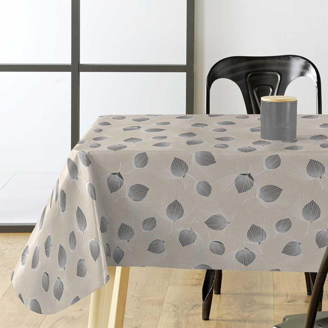 Helga Grå - Vaxduk med ett spännande bladmönster och grå/beige bas. på bordet