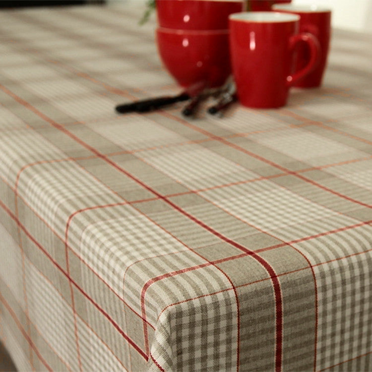 Julduk Olmer Rutor Röd - textilvaxduk i linnelook hörn bild av duken på bordet