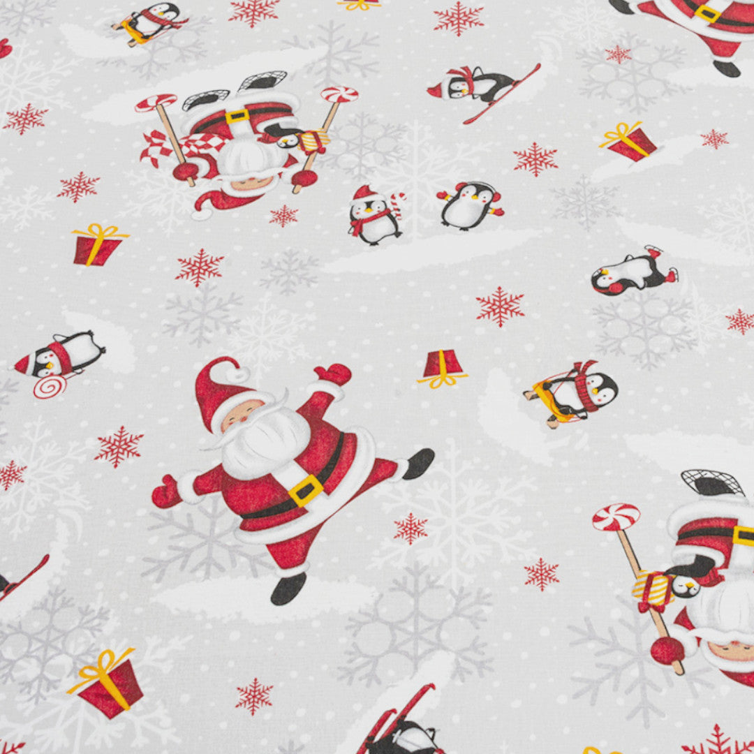 Närbild av Julfest på Sydpolen – duk med tomtar och pingviner i snön