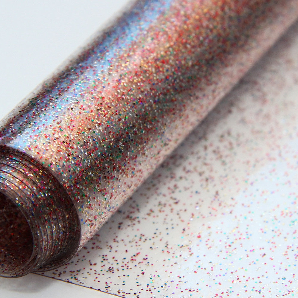 Klar plast Rainbow - Genomskinlig vaxduk med glitter i olika färger. På rulle