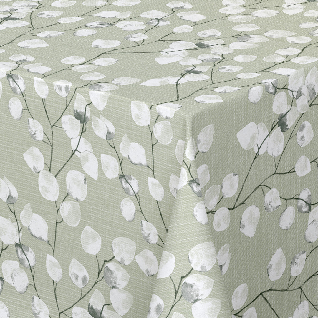 Hörnbild av bordet med Nova Green - ljusgrön vaxduk med vita blad