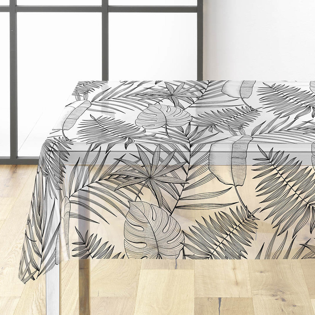 Genomskinlig vaxduk med svart/grå blad på bordet