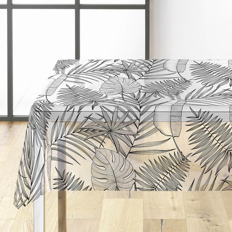 Genomskinlig vaxduk med svart/grå blad på bordet