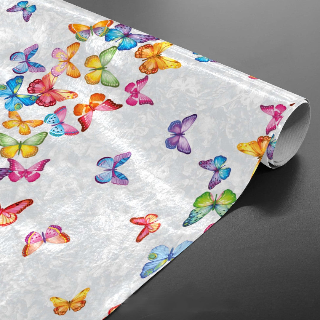 Vaxduk med fjärilar på rad i många färger