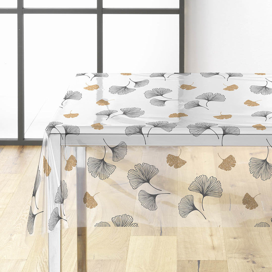 På bordet Ylisse - Genomskinlig vaxduk med ginkgo blad i svart och guld