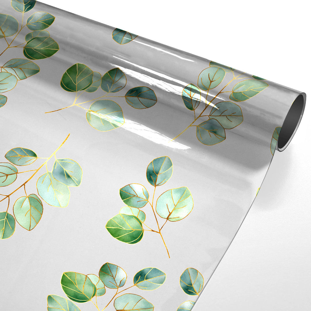 Eucalys – Transparent vaxduk med gyllene bladmotiv, rullad