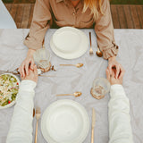 Nordfavn Edna – Textilvaxduk med diskret bladmönster på sandfärgad bakgrund, bord