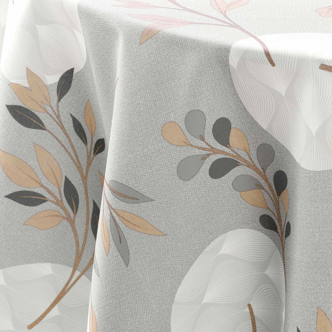 Detaljbild av grå duk med beige bladmönster