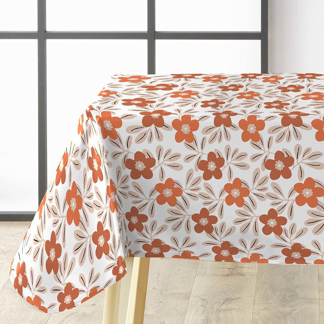 På bordet Flory Orange - Fin vaxduk med blommor i varma färger