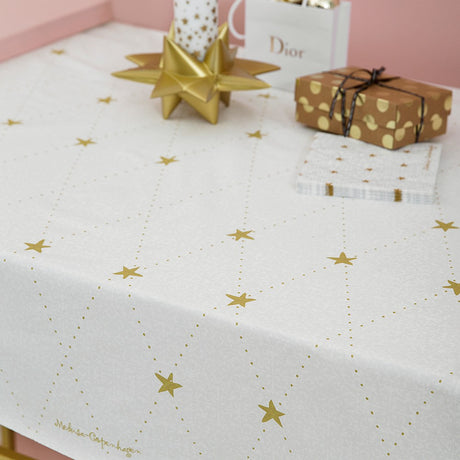 Medusa Stardust gold textilvaxduk med glidskydd, elegant julduk med guldfärgade stjärnor